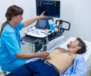 Man getting ultrasound of a abdomen from doctor in hospital